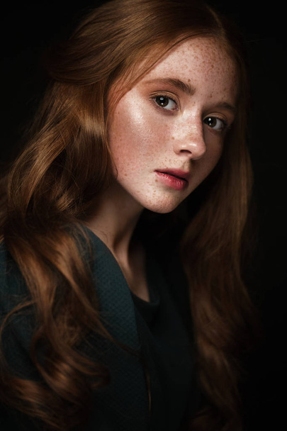 Beautiful Redhead girl with a perfectly curls hair and classic make-up. Beauty face. - Valokuva, kuva