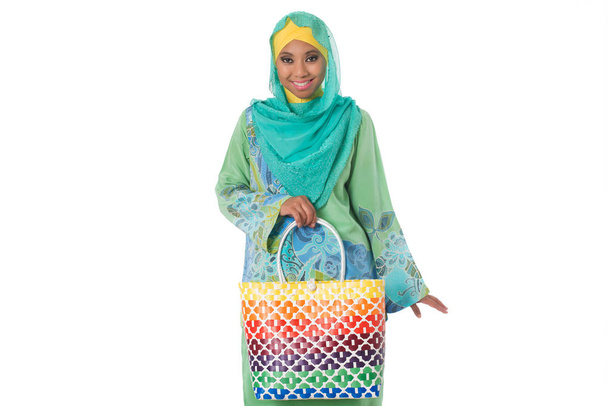 Beautiful asian muslimah woman with bright wicker tote bag.Isolated - Foto, afbeelding