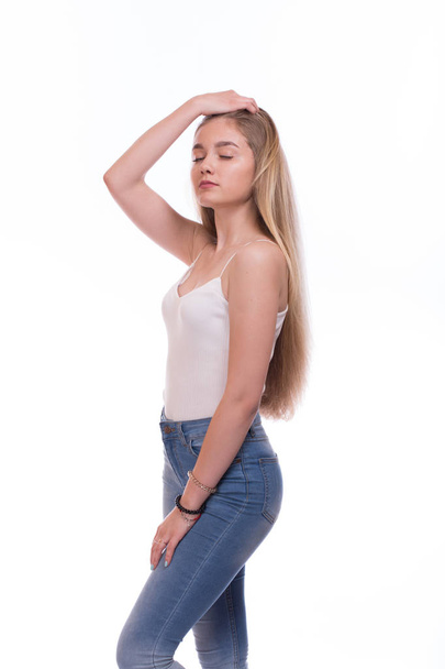 Beautiful blonde young woman standing. Isolated on a white background - Zdjęcie, obraz