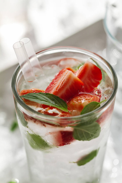 Tasty fresh cold drink with ice, water, mint and strawberry - Zdjęcie, obraz