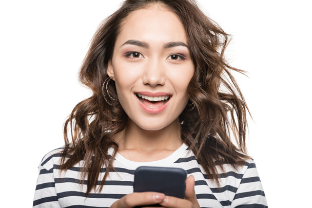 woman with smartphone looking at camera - Photo, Image