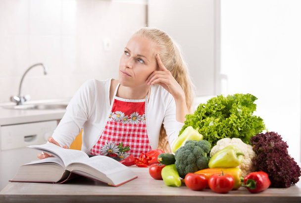 Woman reading recipe book - Foto, Imagem
