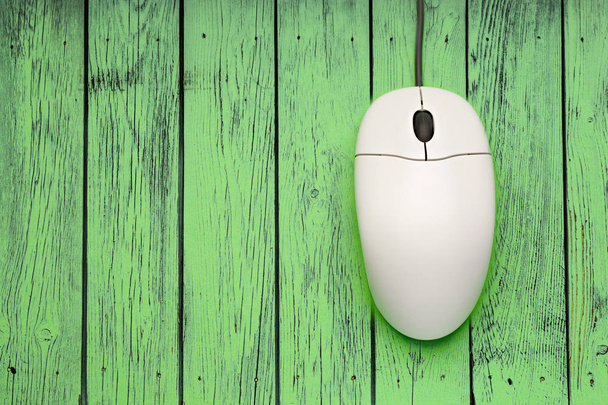 Computer mouse on green wooden background - Photo, Image