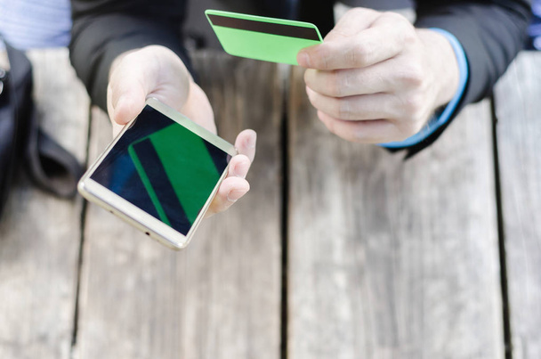 credit card and mobile phone in hand - Photo, Image