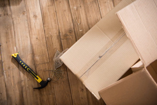 Cardboard boxes on wooden floor  - Fotografie, Obrázek