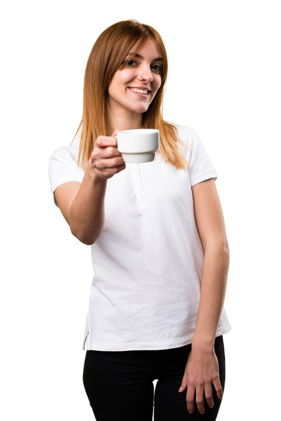 Happy Beautiful young girl holding a cup of coffee - Φωτογραφία, εικόνα