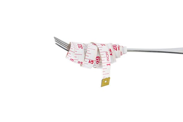 Diet concept, Steel fork and measuring tape isolated - Photo, Image