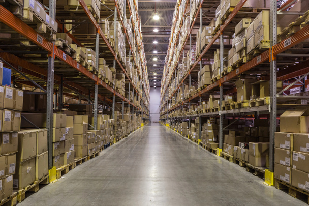Interior of warehouse with racks full of boxes - 写真・画像