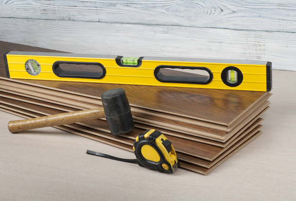 Carpentry concept. Different tools on the new laminate flooring.Copy space for text. - Foto, Imagen