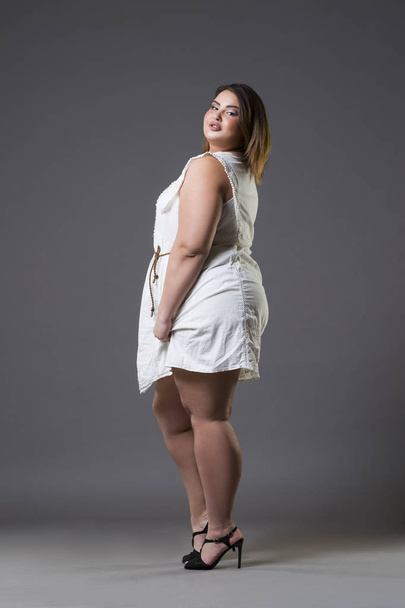 Plus size fashion model in casual clothes, fat woman on gray background, overweight female body - Photo, Image