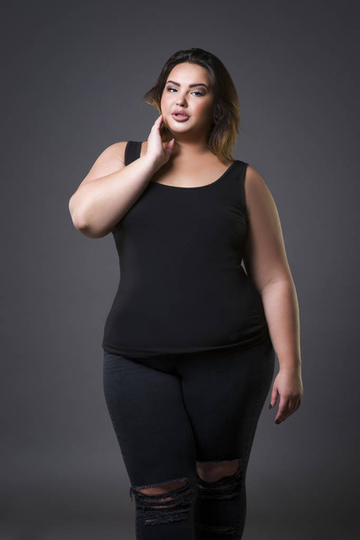 Plus size fashion model in casual clothes, fat woman on gray background, overweight female body - Fotoğraf, Görsel