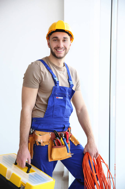 electrician holding bunch of wires and toolbox - Foto, imagen
