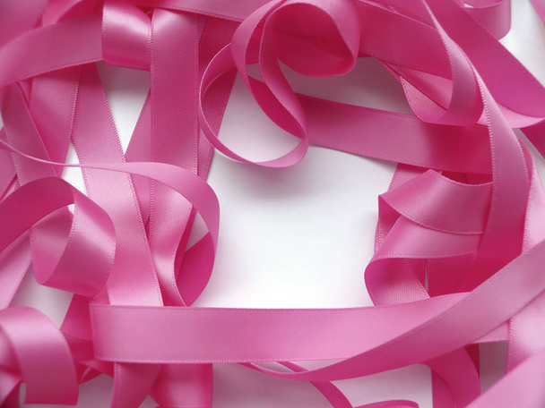 Pink ribbon over white background, design element - Фото, изображение