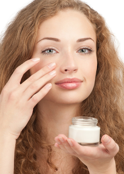Beautiful woman applying moisturizing cream - Photo, Image