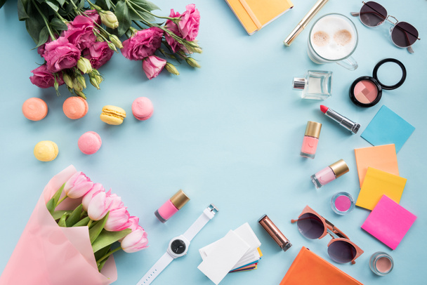 flowers with sunglasses and cosmetics with macaroons - Photo, Image