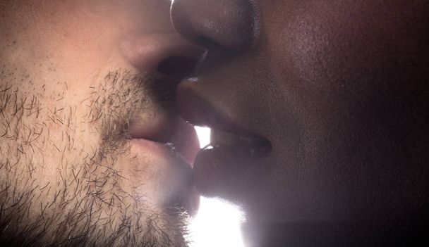 küssendes Paar eouropäischer Mann und dunkelhäutige Frau auf weißem Hintergrund. - Foto, Bild