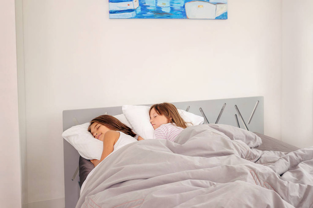 Giovani ragazze che dormono nel letto
 - Foto, immagini