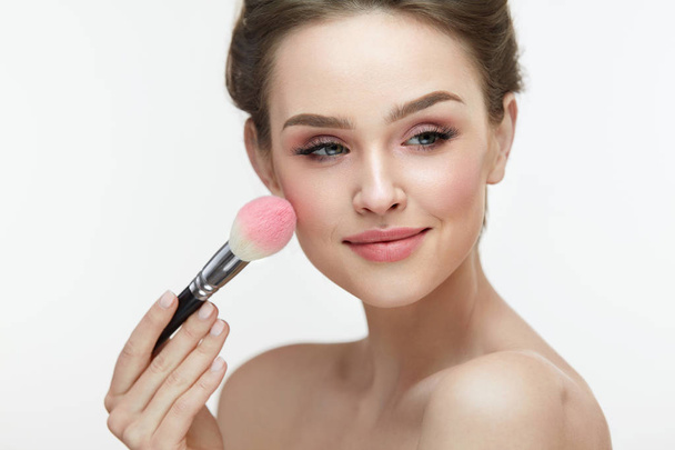 Woman Face Beauty. Sexy Girl Putting Blush With Facial Brush  - Photo, Image