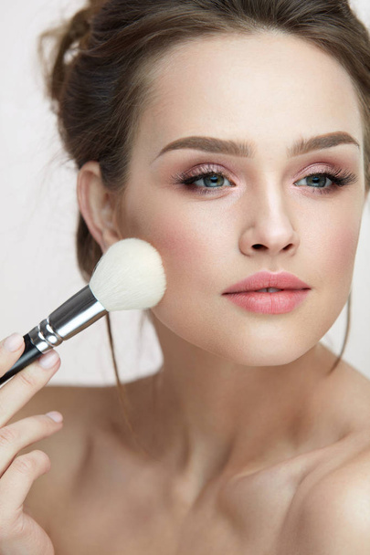 Face Makeup Cosmetics. Beautiful Female Applying Blush - 写真・画像