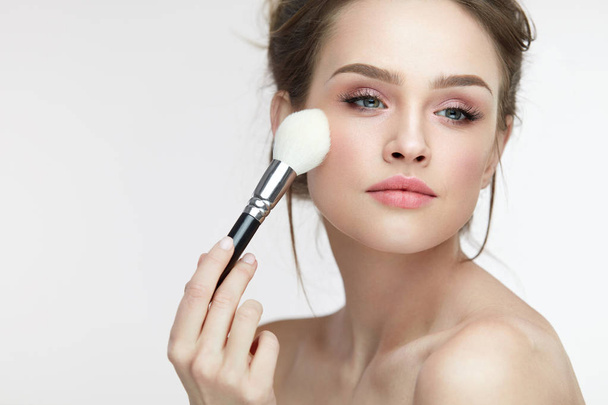 Facial Makeup. Beautiful Female Applying Blush With Brush - Foto, afbeelding