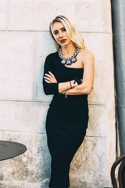  blond woman posing  in black dress - Foto, imagen