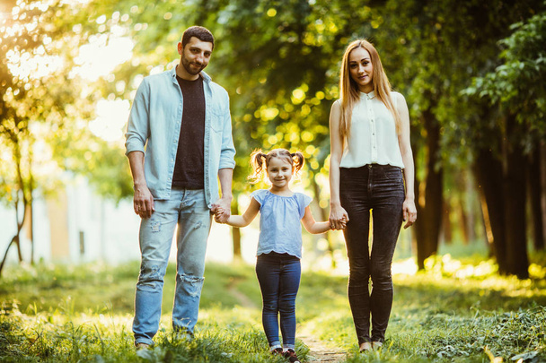young family on a walk in the summer park - Photo, Image