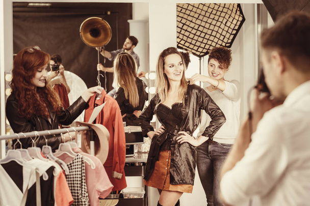 Stylist putting clothes on model - Photo, Image