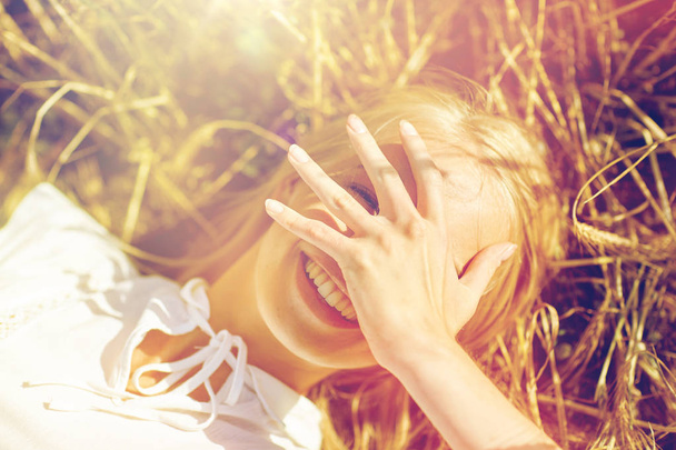щаслива молода жінка лежить на зерновому полі
 - Фото, зображення