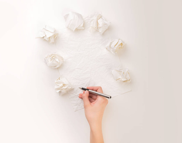 Writing hand in crumpled paper - Foto, imagen