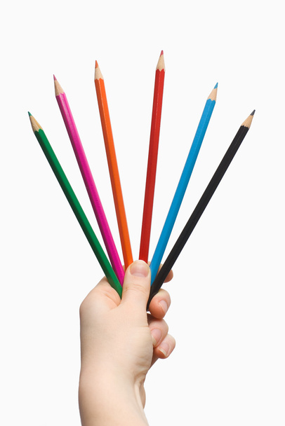 Mão segurando um lápis colorido
 - Foto, Imagem