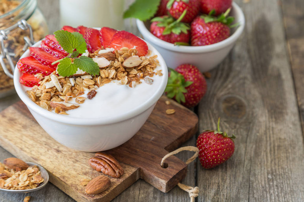 Breakfast - yogurt with granola and straberries - Fotó, kép