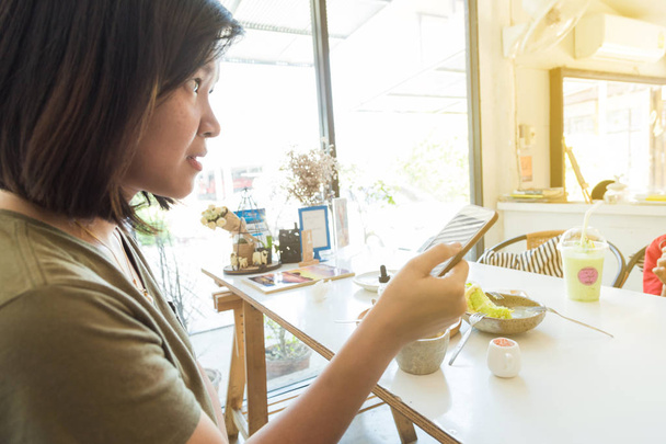 Smartphone on women hand in cafe for communication - 写真・画像
