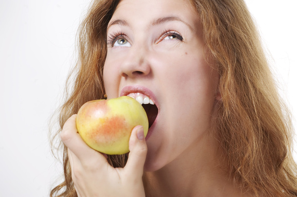 Beautiful girl eating an apple - Фото, изображение