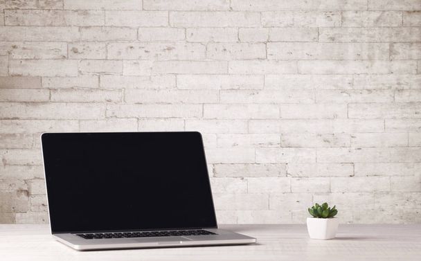 Business laptop with white brick wall - Foto, Imagem