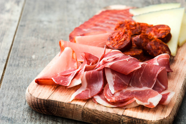 Spanish cold cuts (embutidos). Cheese, sausage and ham on wooden table - Photo, Image