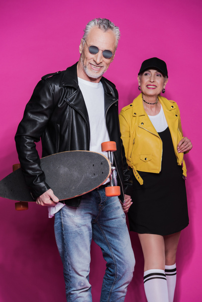 Senior couple with skateboard  - Photo, Image