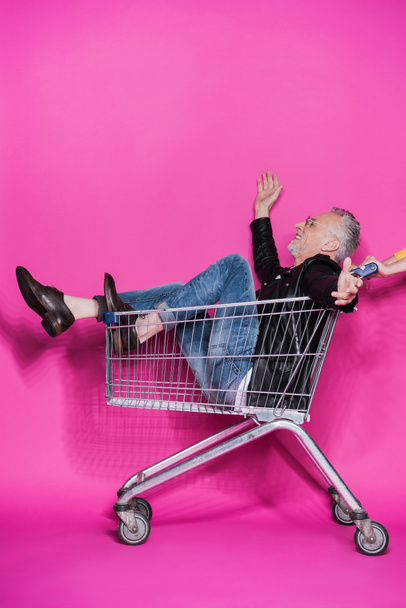 Senior man in shopping trolley  - Photo, Image