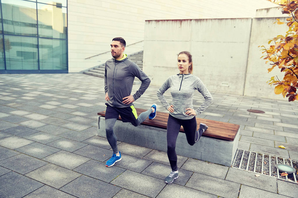 couple doing lunge exercise on city street - Foto, Imagen