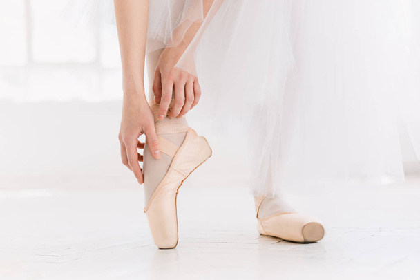 Young ballerina dancing, closeup on legs and shoes, standing in pointe position. - Foto, immagini