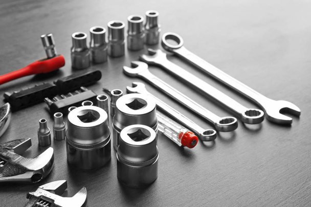 Setting of tools for car repair on grey table - Fotó, kép