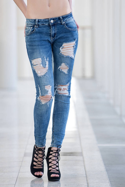 girl in jeans on legs of young woman in fashionable shoes - Foto, Imagem