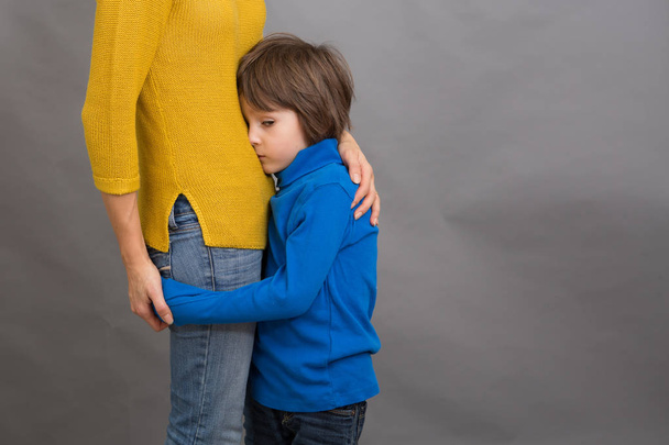Sad little child, boy, hugging his mother at home, isolated imag - Foto, imagen