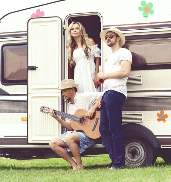 happy friends at camper trailer - Photo, Image