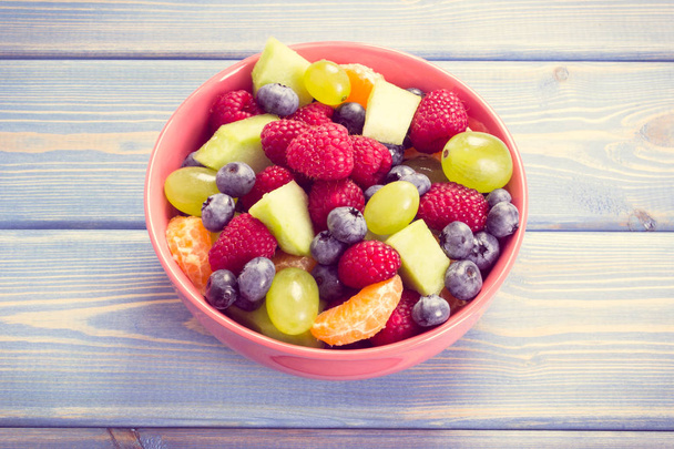 Vintage photo, Fresh fruit salad in bowl, healthy nutrition concept - Photo, image