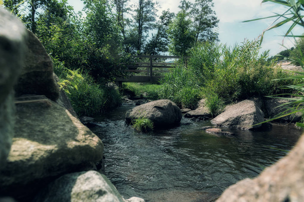 Vista entre piedras en un pequeño río
 - Foto, imagen