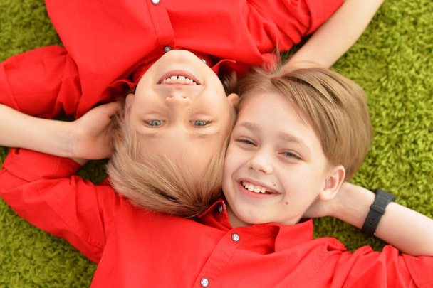 Lächelnde Jungen auf dem Boden liegend - Foto, Bild