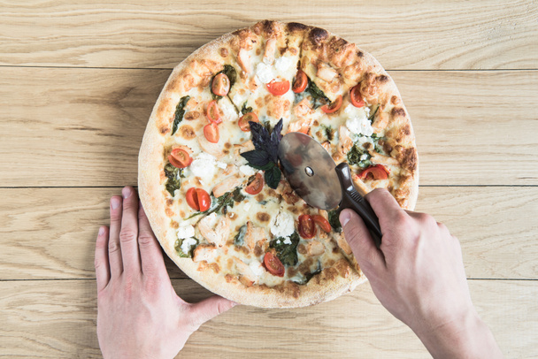 hands cutting italian pizza - Photo, Image