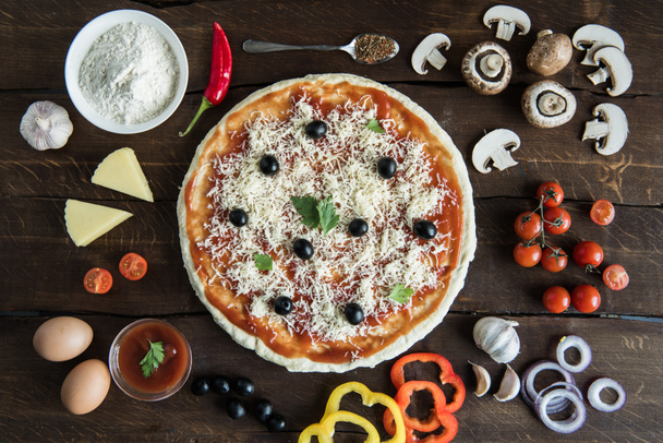 pizza with various ingredients on tabletop - Photo, Image