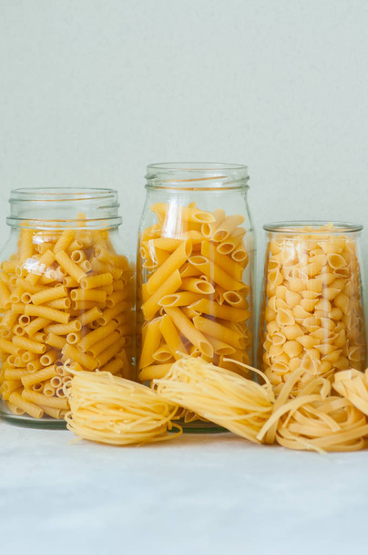 Assortment of different shapes whole grain raw Italian pasta in  - Photo, Image