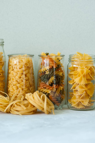 Assortment of different shapes whole grain raw Italian pasta in  - Valokuva, kuva